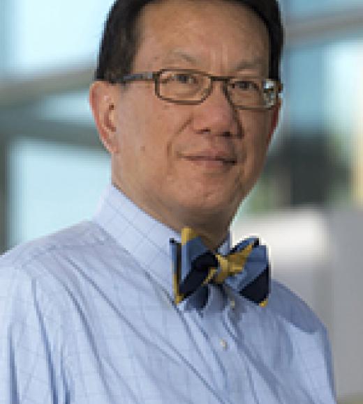 Picture of Dr. Wun, blue button up shirt and bow tie, glasses